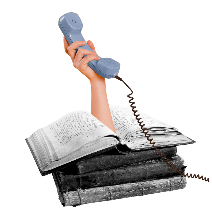 Arm coming out of stack of books holding phone